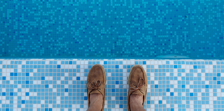 stock image of man standing on tile pool floor